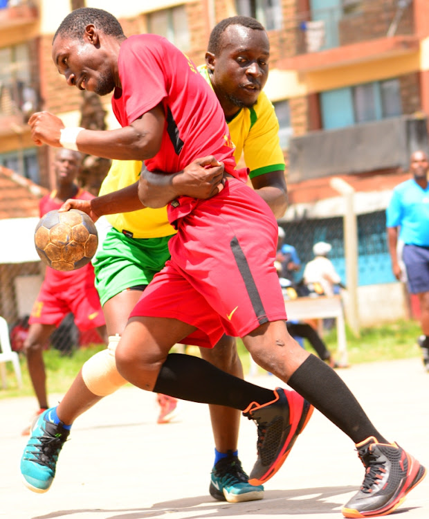 NCPB's Nicholas Okore tackles Gibson Luyari of St,Paul's University during their KHF league match at Kaloleni grounds on November 17,2019.