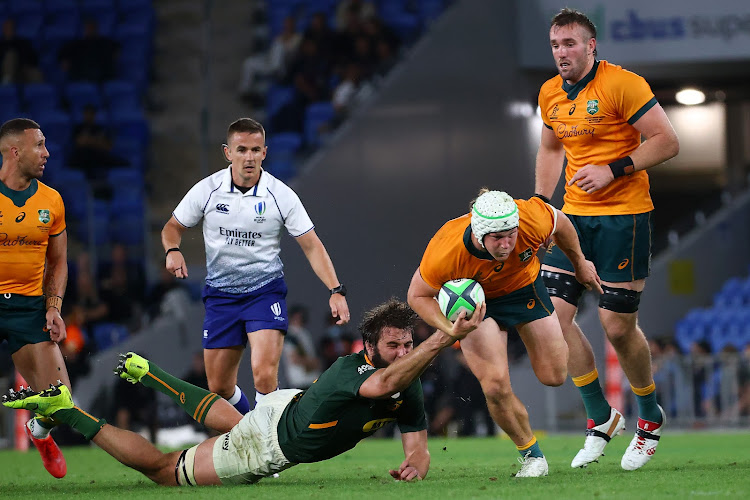 Australia's captain Michael Hooper beats the tackle of South Africa's Lood de Jager during the Rugby Championship match at Cbus Super Stadium in Gold Coast on September 12, 2021.