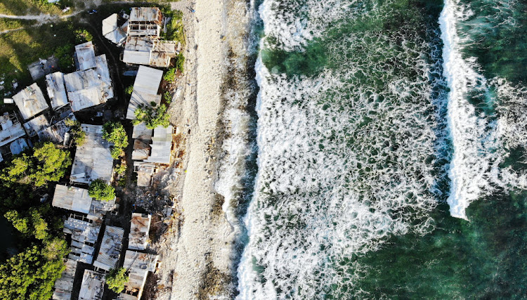 An aerial view of homes next to the Pacific Ocean on November 28 2019 in Funafuti, Tuvalu. Picture: GETTY IMAGES/MARIO TAMA.