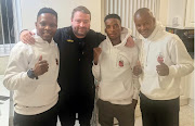 Manager Michael Sediane right, boxer Sohelele Myeza and trainer Vusi Malinga with promoter of Myeza's Commonwealth title in England on Saturday. 