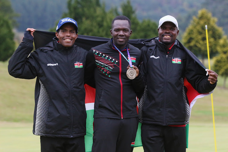 Isaac Makokha (C) poses with his teammates Adan Wario (L) and Gilbert Alikula