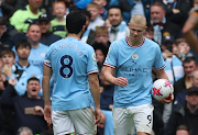 Manchester City's Erling Haaland gives the ball to Ilkay Gundogan to take a penalty.