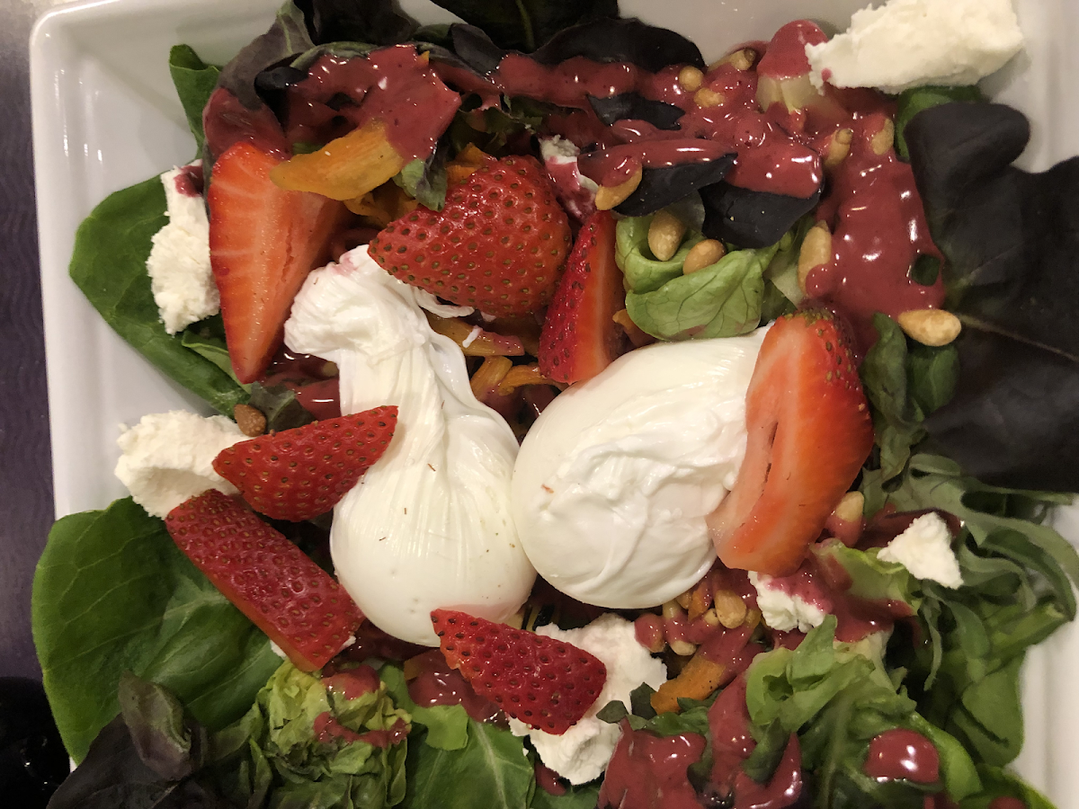 Special breakfast salad - strawberries, blueberries, roasted carrots, poached eggs. Delicious