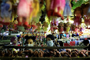 Egyptian women wearing face masks amid the coronavirus disease (Covid-19) outbreak, buy Aroset El Moulid or (Bride of Moulid) doll toys to celebrate the birthday of Prophet Muhammad, also known as 