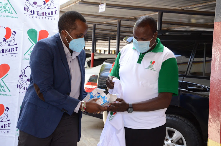 Heart to Heart Foundation director Joe Nyaga and The Karen Hospital head of security Patrick Njogu.