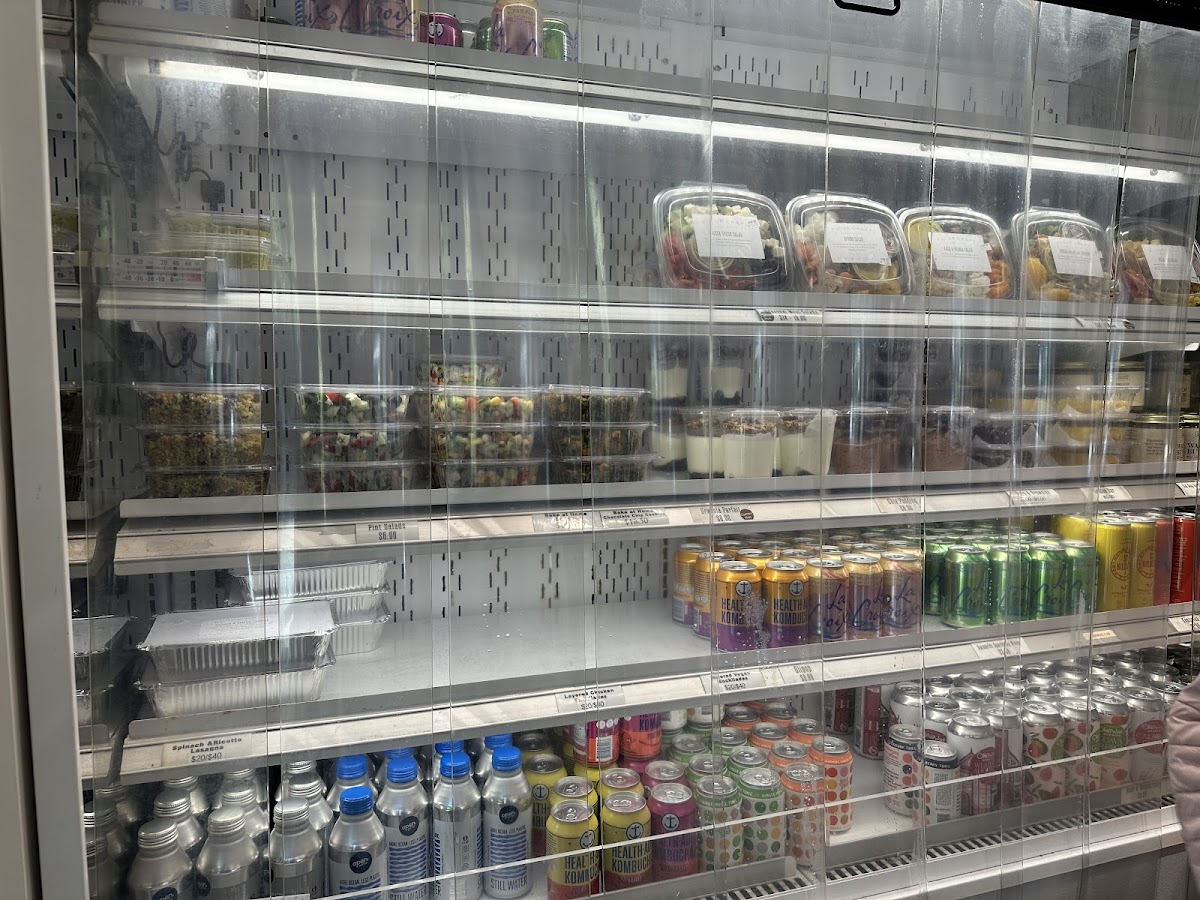 Grab and go cooler with drinks, deli salads, green salads, lasagna, yogurt, desserts