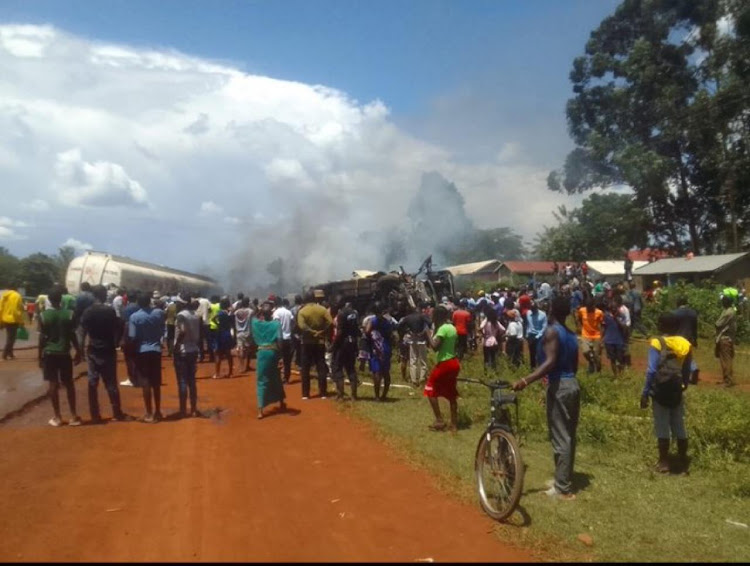 Kenyans gather after a bus collided with an oil tanker in Busia on March 1, 2024.