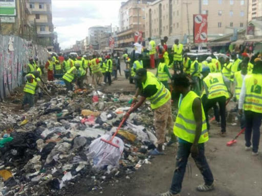 Members of the Sonko Rescue Team collect garbage in Eastlands, Nairobi, May 23, 2017. /COURTESY