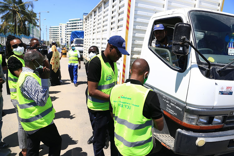 KFS and Safaricom officers take motorists through the new system of paying toll charges at the Likoni crossing channel on October 8, 2020