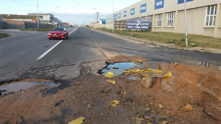 A car heading north on Burman Road on Tuesday morning veers across into the wrong lane to bypass the sewage and pothole morass opposite Adolph Street