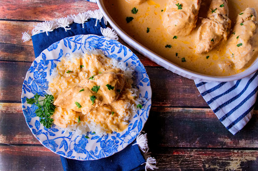 Fix It and Forget It Creamy Chicken on a plate with rice.