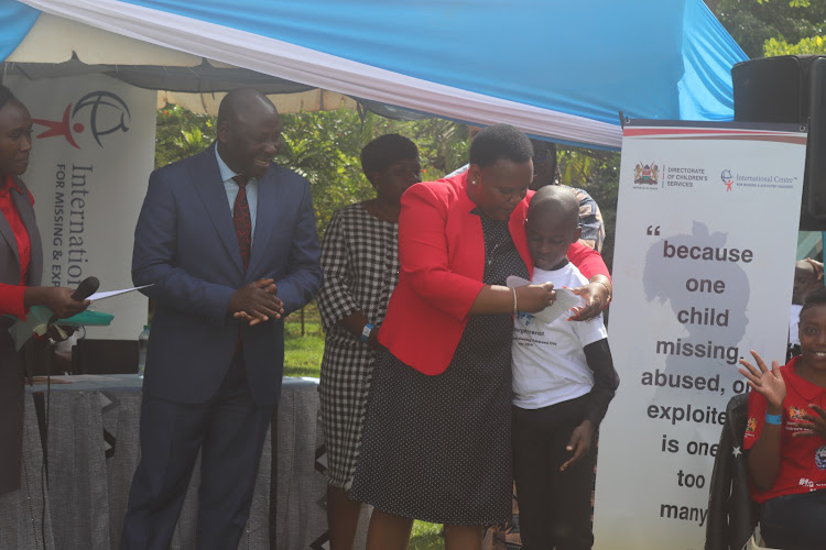 Labour CS Florence Bore embraces an unidentified child at Shalom House during the International Missing Children Day on May 26,2023.