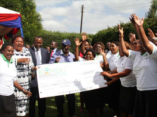 Kiambu Governor William Kabogo with CEC Youth Affairs and Sports Mr. Machel Waikenda handing over Ksh29 Million from the Biashara Fund kitty to Youth, Women and PWDs drawn from Saccos in Kikuyu Sub-county yesterday. Photo/George Mugo