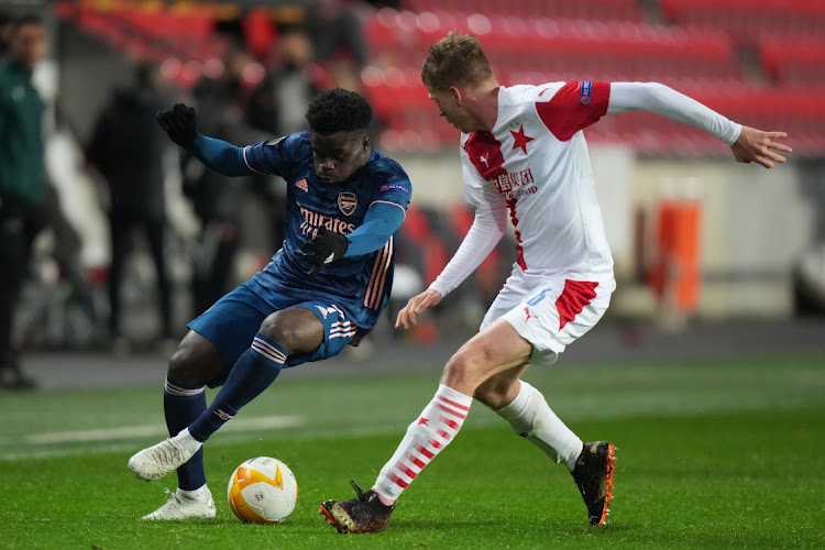 Bukayo Saka of Arsenal battles for possession with David Zima of Slavia Prague during the Europa League quarterfinal second leg match at Sinobo Stadium on April 15, 2021 in Prague