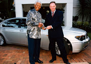 Madiba had a number of BMWs during his presidential term, and is seen here getting the keys to a 7 Series in the late 1990s from former BMW SA boss Ian Robertson. 
Picture: SUPPLIED