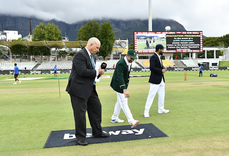 India captain Virat Kohli and SA captain Deal Elgar conduct the toss prior on day one of the third Test at Newlands in Cape Town on January 11 2022.