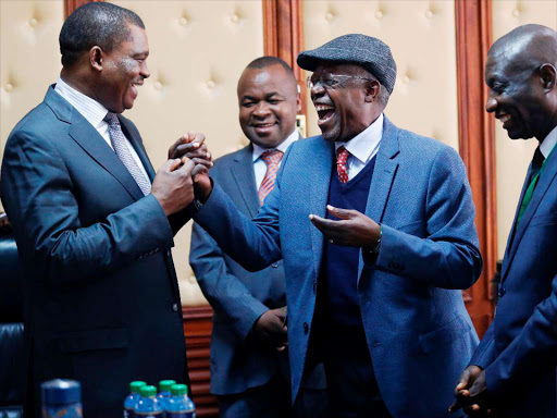 Speaker Justin Muturi and President of African Parliamentarians' Network Against Corruption share a light moment with board members (from L) Chris Wamalwa, Musikari Kombo and Jean Pierre Passi of DR Congo moments before the start of the Inaugural board meeting with an aim to develop, maintain and promote a network to build the capacity of Parliaments and Parliamentarians in Africa to fight corruption. July 27, 2018. Photo/Jack Owuor