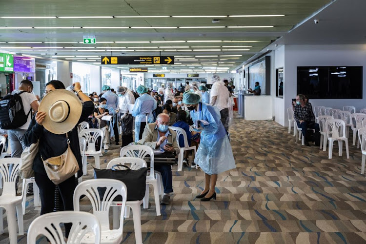 Health workers check the documents of international travellers arriving at Phuket International Airport. Picture: ANDRE MALERBA/BLOOMBERG
