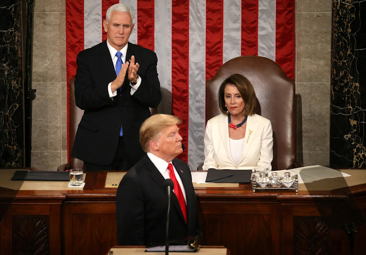 Speaker of the House Nancy Pelosi (D-CA) reacts alongside Vice President Mike Pence as he applauds US President Donald Trump during his second State of the Union address to a joint session of the US Congress in the House Chamber of the US Capitol on Capitol Hill in Washington, US February 5, 2019.