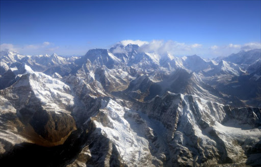 This photograph taken from an aircraft shows an aerial view of Mount Everest (C) and The Himalayan mountain range, some 140kms (87 miles) north-east of Kathmandu on April 3, 2013, on the 80th anniversary of the first manned flight over Mount Everest, the world's tallest mountain. This year is the 60th anniversary of the first summit of the 8848-metre peak.