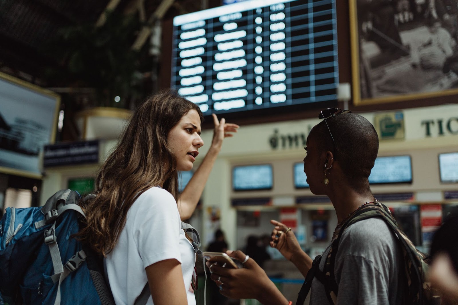 Airport Meet and Greet Services, A woman is guiding another woman at the airport. 