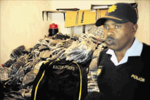 fakes galore : Gauteng police spokesman Major Mack Mngomezulu says the Johannesburg house where illegal Kaizer Chiefs merchandise was found was under surveillance for some time Photo: Thulani Mbele