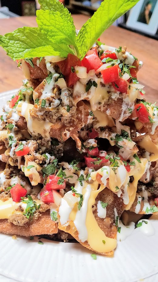 Expatriate Nachos, available at brunch Sat Sun 10am - 2pm and early and late night on weekdays only (between 5-6 pm or after 10 pm only). Fried wonton chips, thai chili cheese sauce, spicy lemongrass beef, crema, kaffir lime & tomato salsa, herbs