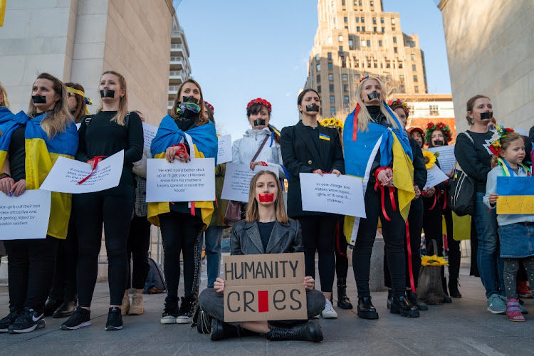 People participate in a flash mob protest against the Russian invasion of Ukraine, in Manhattan, New York City.