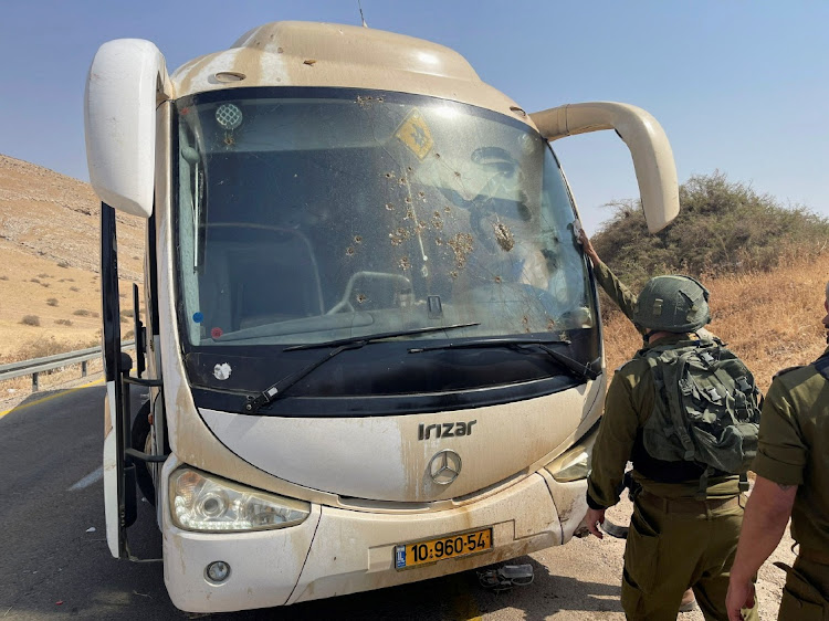 Israeli soldiers check damage in a bus at the scene of a shooting attack in the Jordan Valley, September 4 2022. Picture: REUTERS/ADEL NEMEH