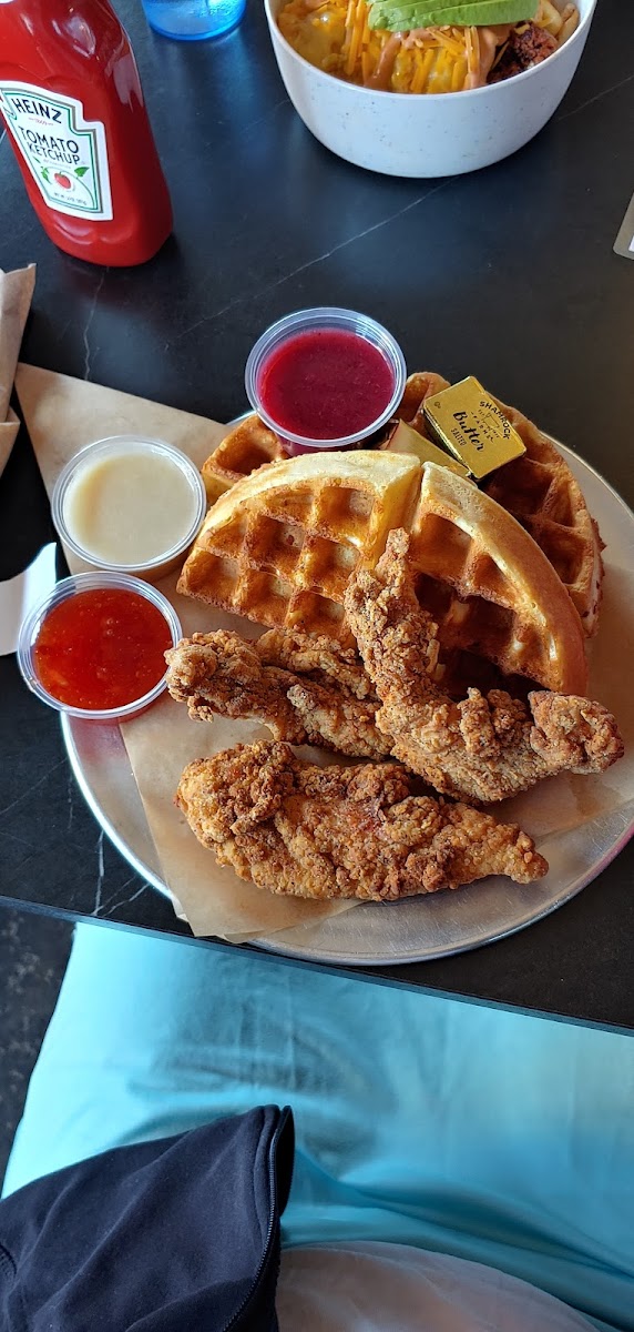 Chicken and waffles with sweet-and-sour sauce, buttermilk frosting dip, and homemade jam.