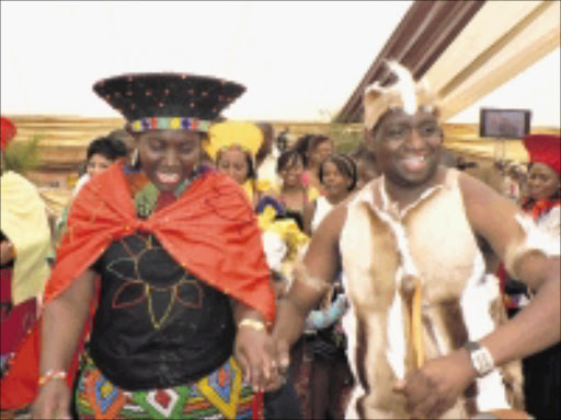 WEDDED BLISS: Bruce Kgapane and his wife Nolwazi, now Napogadi, at their wedding ceremony yesterday. Pic: RIOT HLATSHWAYO. 11/10/2009. © Sowetan.