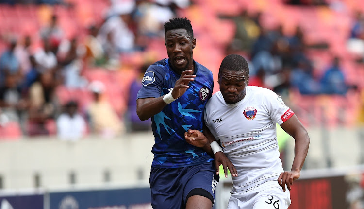 Evans Rusike of Swallows FC and Siphelele Luthuli of Chippa United compete for the ball in the DStv Premiership match at Nelson Mandela Bay Stadium in Gqeberha on February 26 2023.