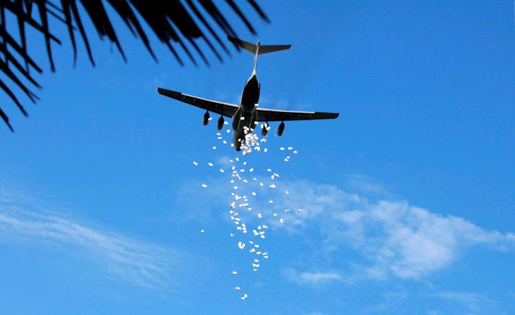 A United Nations World Food Programme (WFP) aeroplane releases sacks of food during an airdrop near the town of Nyal in South Sudan in August this year. (File photo)