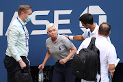 A file photo of Novak Djokovic attending to a lineswoman after inadvertently striking her with a ball hit in frustration during his fourth round match against Pablo Carreno Busta of Spain on Day Seven of the 2020 US Open.