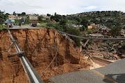 KwaZulu-Natal faces a mammoth rebuild task after damage wrought by floods in the province, including this 15m-wide hole in Ntuzuma where a bridge once stood. File photo.