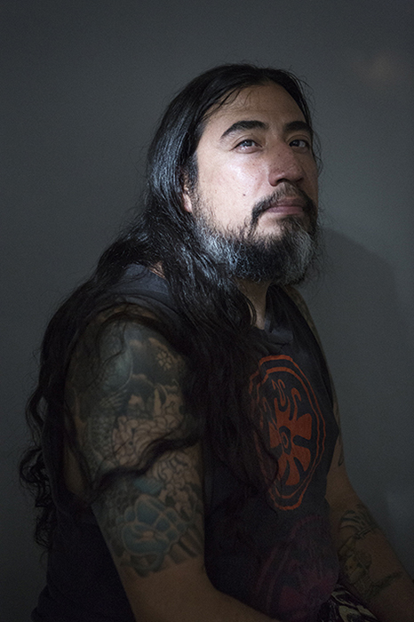 Long haired and tattooed interviewee helps represent the diverse group of believers in the UFO community. 