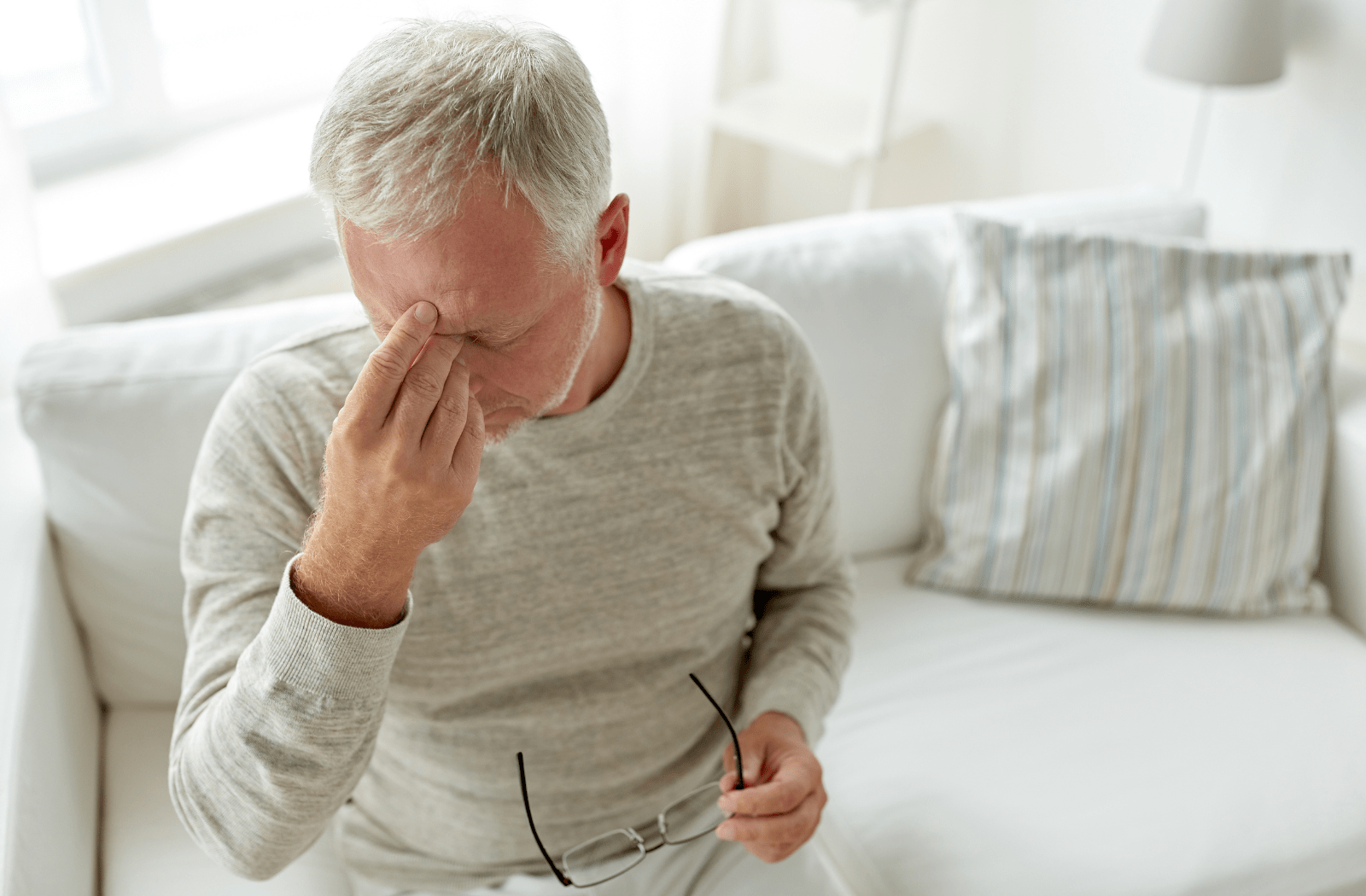 An older man rubbing his eyes due to dry eye