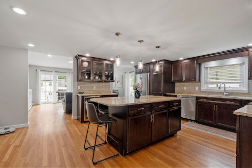 Modern kitchen with dark brown island in this luxury property for sale in Melrose ($1,200,000)