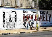 People pass a mural painted in Johannesburg that depicts the fall into a pit toilet at his school in Limpopo of Michael Komape. File photo.