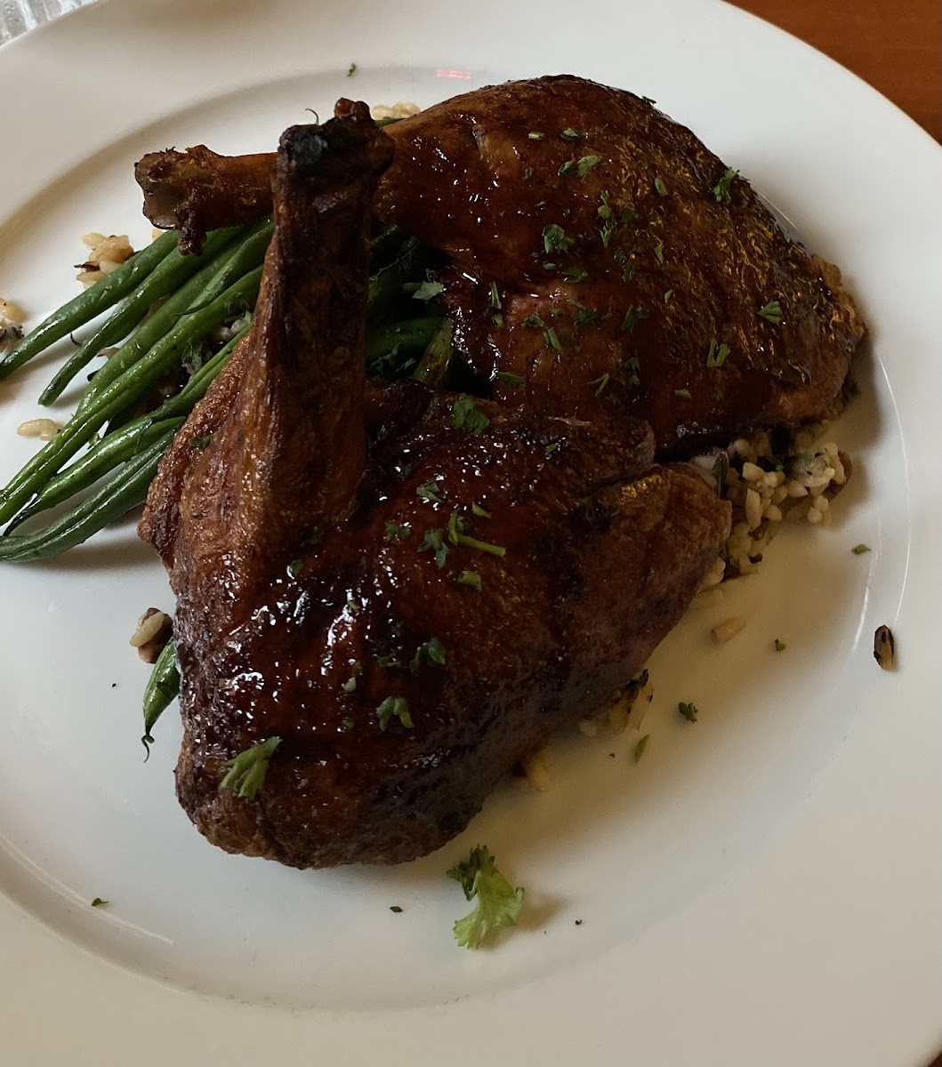 Rapberry port reduction on duck with pecan rice and haricot verts