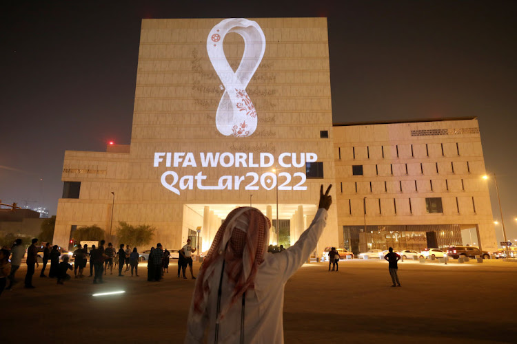 The official emblem of the Fifa World Cup Qatar 2022 is projected onto the Qatar National Archive Museum buildiing in Doha.