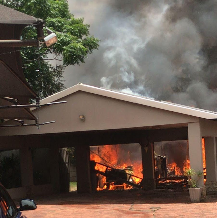 The blazing house from which a blind and deaf dog and two cats were rescued on Sunday.