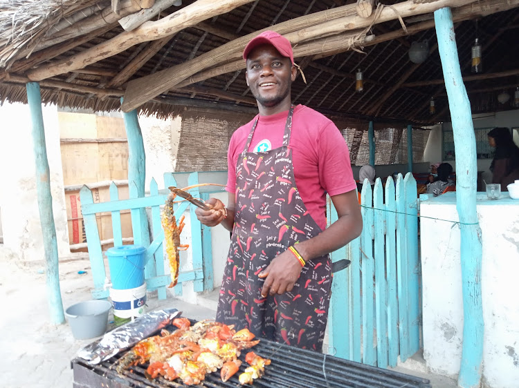 David Tuva barbecues lobsters on the streets of Lamu Island.