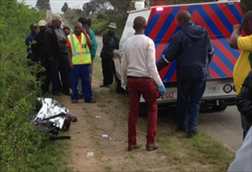 A crowd gathers around the dead body of one of the pedestrians killed his morning by an ambulance in Port Alfred Picture: David Macgregor