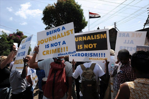 Foreign journalists hold banners as they march to the Egyptian Embassy in Nairobi,