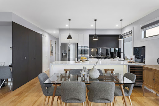 Modern kitchen with island and dining area in this luxury house for sale in Mornington