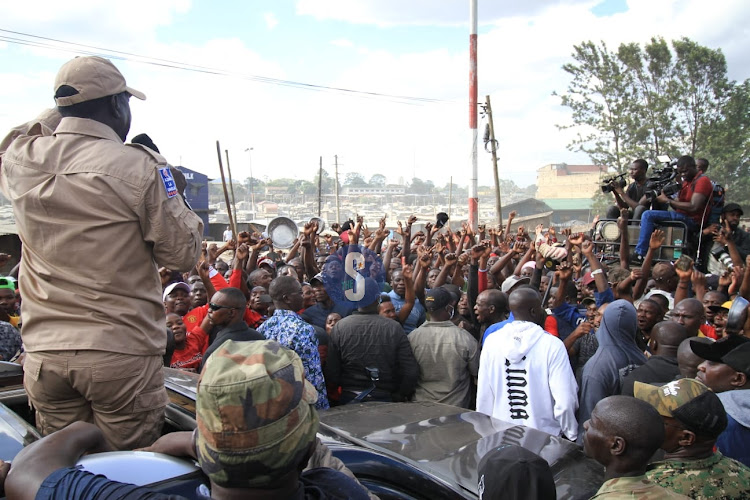 Azimio leader Raila Odinga addressing protesters during mass action rally in Nairobi on Monday.