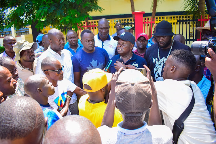 Kisumu Central MP Joshua Oron (in cap) flanked by other local leaders addresses the Media after meeting police bosses in Kisumu on Tuesday, May 9, 2023.