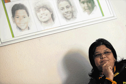 Michelle Ohlsson with a portrait of her son. Matthew, above left, who has been missing for 15 years. Michelle and her husband started Concerned Parents of Missing Children in 1999 to assist other parents find their children Picture: SHELLEY CHRISTIANS