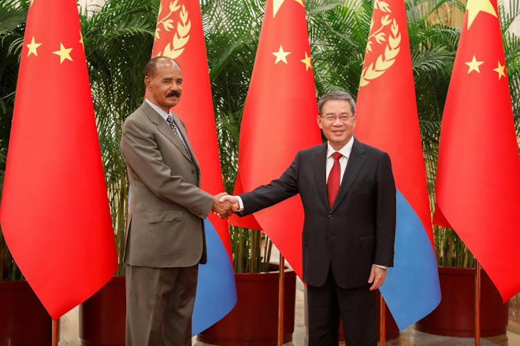 Chinese Premier Li Qiang and Eritrean President Isaias Afwerki shake hands as they attend a meeting at the Great Hall of the People in Beijing, China, May 15 2023. Picture: FLORENCE LO/REUTERS